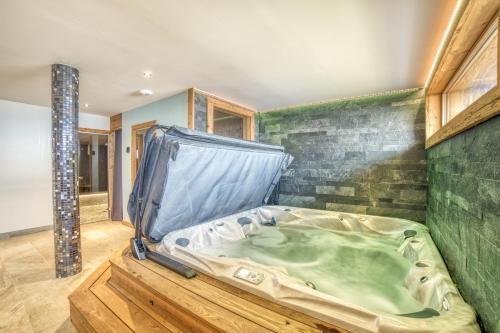 a hot tub in the middle of a room at Chalet face au Mont-blanc in Sallanches