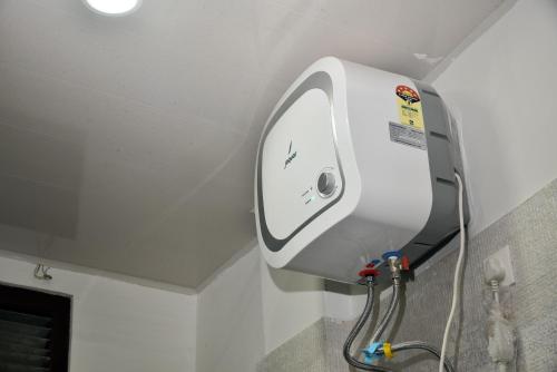 a soap dispenser on the wall of a bathroom at Rufina Palm Bliss in Pelling
