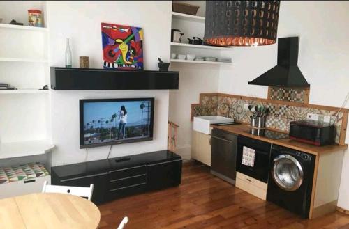 a living room with a flat screen tv on a wall at One bedroom with garden in London