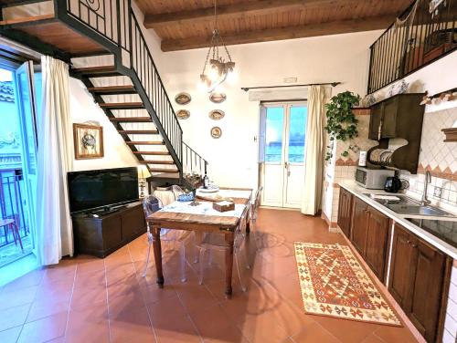 a kitchen with a wooden table in a room at La Casa Delle Fate in Siracusa