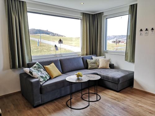 a living room with a couch and a table at Good times @ Salzburg in Habach