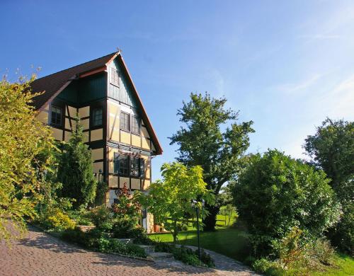 a large house with trees in front of it at Kölliger Hirtenhaus in Köllig