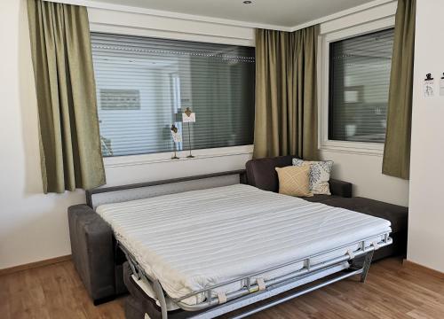 a hospital bed in a room with a window at Good times @ Salzburg in Habach