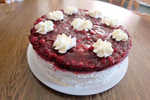 a cake on a white plate on a table at Café Pension Sonnenkanzel in Staatsbad Brückenau