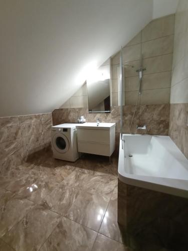 a bathroom with a tub and a sink and a shower at Apartments Captain Morgan Prague in Prague