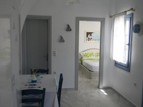 a bedroom with a bed and a table and a mirror at Υδρία-Κατοικίες Hydria-Houses in Pera Gyalos