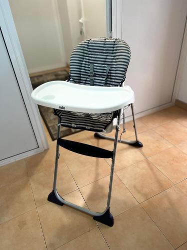 a white chair sitting on a tile floor at Wohnung 18 in Lutherstadt Eisleben