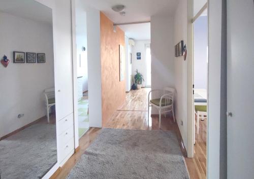 a hallway with a table and a chair in a room at Apartments Zagreb Point in Zagreb