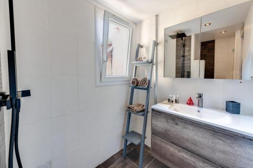 un baño con lavabo y espejo en Le Duplex atypique superbe coeur centre ville, en Annecy