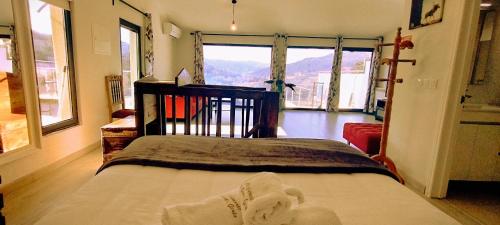 a bedroom with a bed and a large window at Alojamento de Crasto - Gerês in Geres
