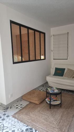 a living room with a bed and a window at Appartement Cosy Saint Cyprien in Saint-Cyprien