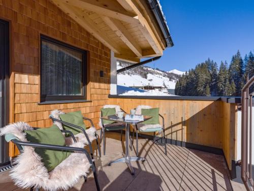 a patio with a table and chairs on a deck at Waidmannsruh Appartements in Gerlos