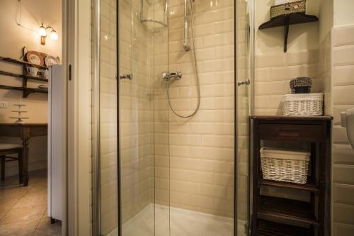 La salle de bains est pourvue d'une douche avec une porte en verre. dans l'établissement Il Calamaio, à Vérone