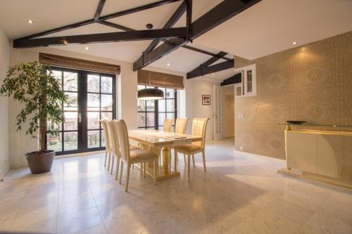 a kitchen and dining room with a table and chairs at The Royal Suite - R.Q.C. in The Hague