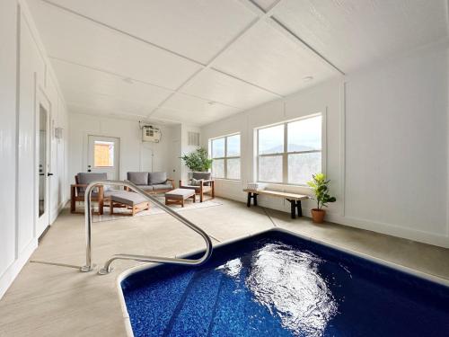 a large room with a swimming pool in the middle of a living room at Modern Cabin w Indoor Pool MTN View Game Room in Pigeon Forge