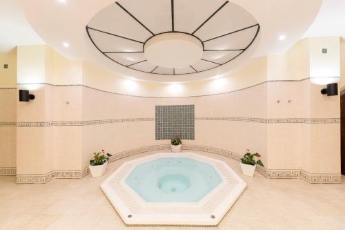 a hot tub in a room with a large ceiling at Aldiana Club Costa del Sol in La Alcaidesa