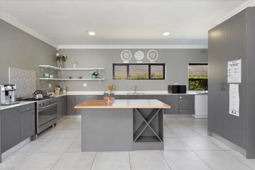 a kitchen with gray cabinets and a large island at 2 On Lismore Guesthouse in Tokai