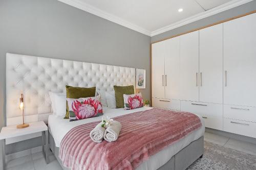 a bedroom with a large bed with two towels on it at 2 On Lismore Guesthouse in Tokai