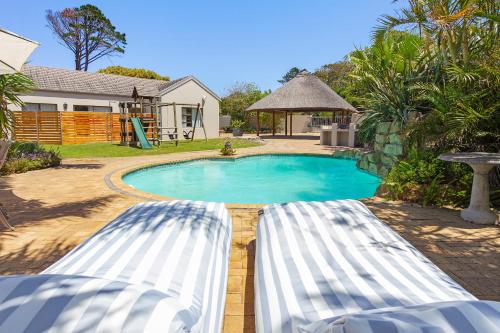 a swimming pool in a yard next to a house at 2 On Lismore Guesthouse in Tokai