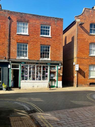 an empty street in front of a brick building at The Farthings, Romsey Apartment in Romsey