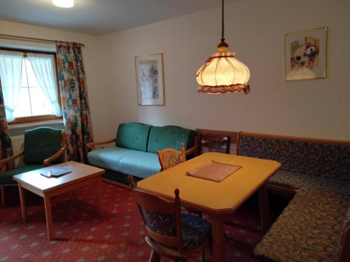 a living room with a couch and a table at ciao-aschau Grenzhub FeWo 208 Bär in Aschau