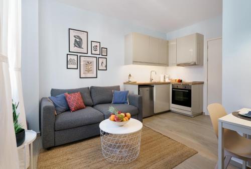 a living room with a couch and a table at THYME Brand New 1BD apart in the heart of Rethymno in Rethymno
