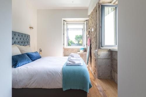 een slaapkamer met een groot bed met blauwe kussens bij Swimming Pool Luxury House 1 in Porto