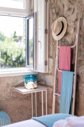 a hat and two towels sitting next to a window at Swimming Pool Luxury House 1 in Porto