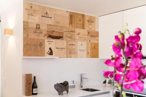 une cuisine avec des placards en bois et une fleur violette dans l'établissement Wine Luxury House, à Porto