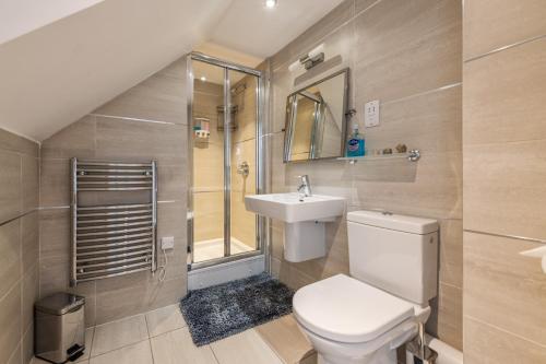 a bathroom with a toilet and a sink and a shower at Skyline Retreat with Unmatched Panaromic Views and Secure Parking in Liverpool