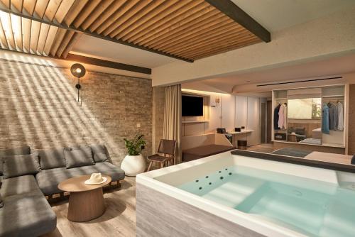 a living room with a large tub in the middle at Nautilux Rethymno by Mage Hotels in Rethymno Town