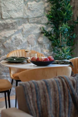 a table with a bowl of fruit and wine glasses at Swimming Pool Luxury House 2 in Porto