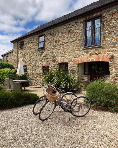 a bike parked in front of a stone building at Callestock Courtyard Cottages in Truro