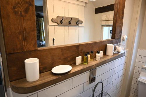 a bathroom with a sink and a mirror at Holly Lodge Boutique B&B in Thursford