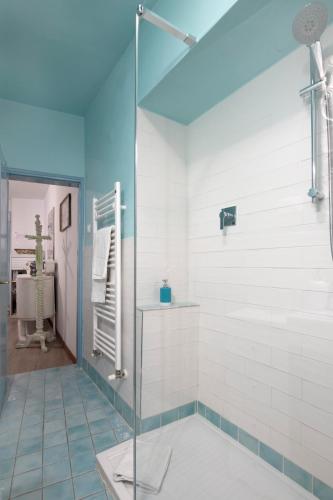 a bathroom with a glass shower and a sink at Il Nido del Canterino in Perugia
