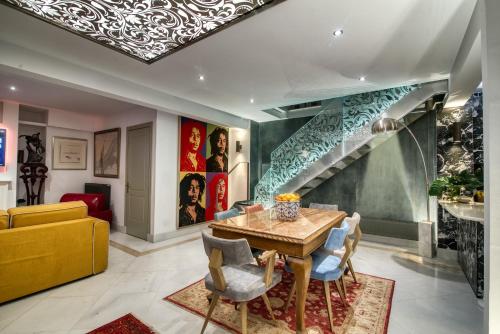 une salle à manger avec une table et un escalier dans l'établissement Farmaki Residence, Plaka, à Athènes