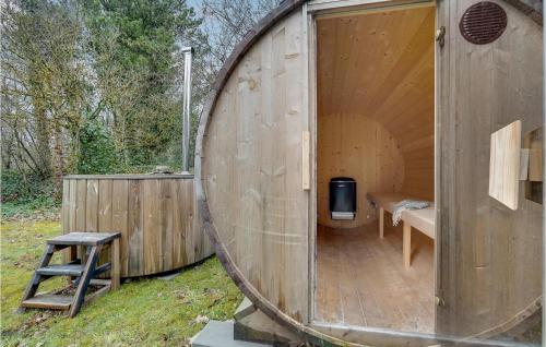 a large wooden barrel house with a bench inside at 4 Bedroom Gorgeous Home In Oksbøl in Oksbøl