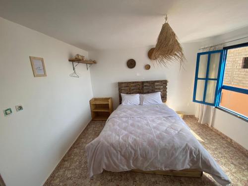 a bedroom with a bed in a white room at Sable beach surf camp taghazout in Taghazout