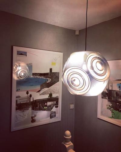 a light fixture in a room with pictures on the wall at Handbridge in Chester sleeps 7 with BT Sports & Pac-man in Hough Green