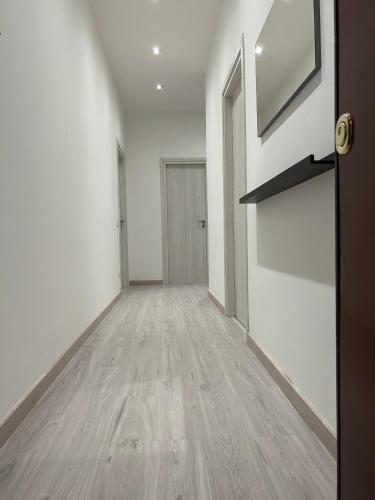 an empty hallway with a door and a wooden floor at Palmira's Rome Sweet Home in Rome