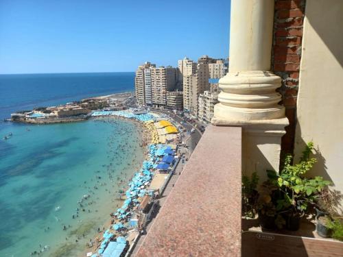 a balcony with a view of a beach and the ocean at Stunning Sea View Flat (One Bed Room)Entire Place in Alexandria
