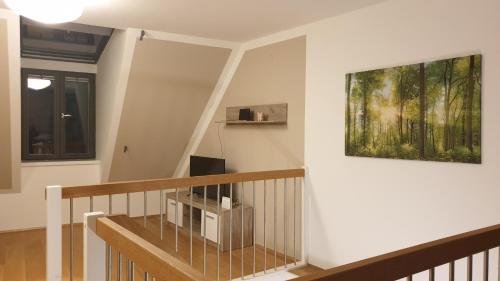 a room with a staircase with a painting on the wall at Elegance Apartment in Vienna