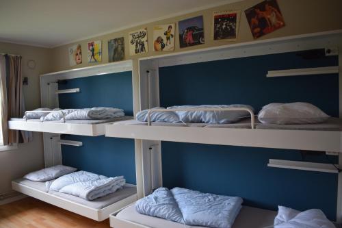 four bunk beds in a room with blue walls at HI Oslo Haraldsheim in Oslo