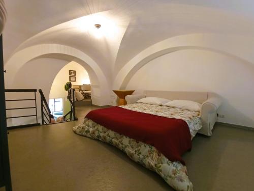 a bedroom with a bed with a red blanket at Villetta Marianna in Bari Palese