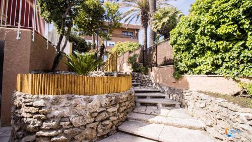 a stone walkway with a retaining wall and a stone fence at Baia di Luna in Santa Marinella