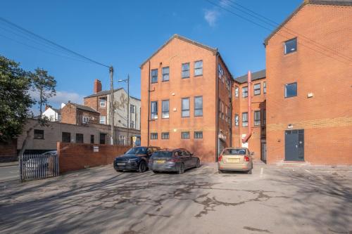 a group of three cars parked in a parking lot at SPECIAL OFFER!! Wednesbury, 1& 2 Bedroom Apartments with Private Parking by 12Stay in Wednesbury