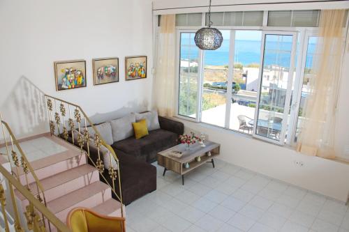 a living room with a couch and a table at Theodore Seaview Home in Sfakaki