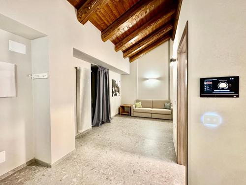 a hallway with a living room with a couch at Case Verdi in Bardonecchia