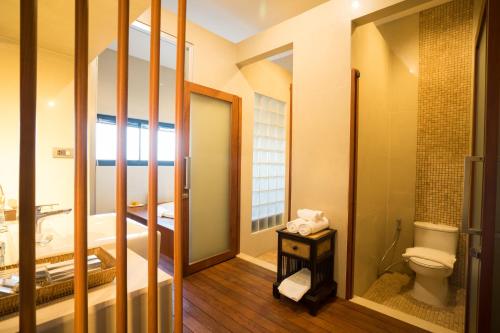 a small bathroom with a toilet and a sink at Amanta Hotel Nongkhai in Nong Khai