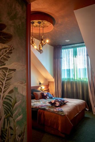 a bedroom with a bed with a large window at AURORA Tarnów in Tarnów